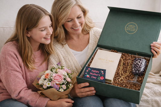 Teenage daughter giving her mum a Just Because Club gift box with flowers on Mother’s Day.